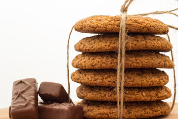 Oatmeal cookies on a wooden board, white background