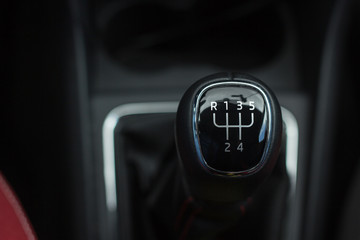 manual transmission gear shift, on dark background