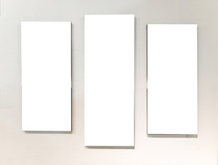Three Blank White Rectangle Picture Frames on a Wall