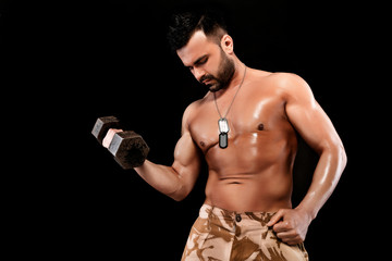 Naklejka premium muscular man doing exercises with dumbbells.