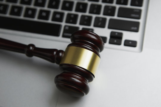 Online auction concept. Auction or judge gavel on a computer keyboard