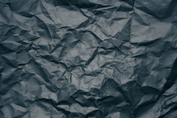 black wrinkled paper texture.