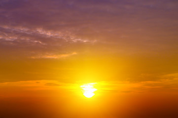 Obraz na płótnie Canvas Cloudy sky and bright sun rise over the horizon.