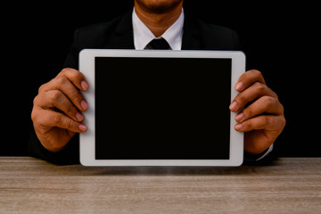 Business concept. Businessman is playing mobile on black background. Business people are browsing the Internet with information technology. Group Businesses interested in Internet knowledge.