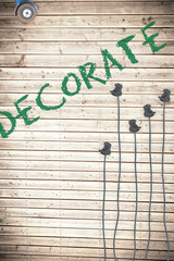 The word decorate  against plugs on wooden background