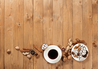 Cup of coffee and cookies on wooden background, spice and decoration, blank space for text, top view, retro style