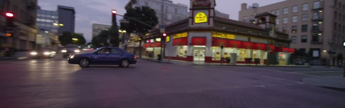 Rear view of a Driving Plate: Car turns left from 3rd Street onto Broadway in Los Angeles, continues to a right turn onto 5th Street, and travels one block on 5th to a stop light.