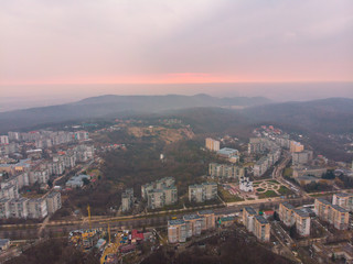 beautiful cityscape with sunrise. red sun rise above the mountains