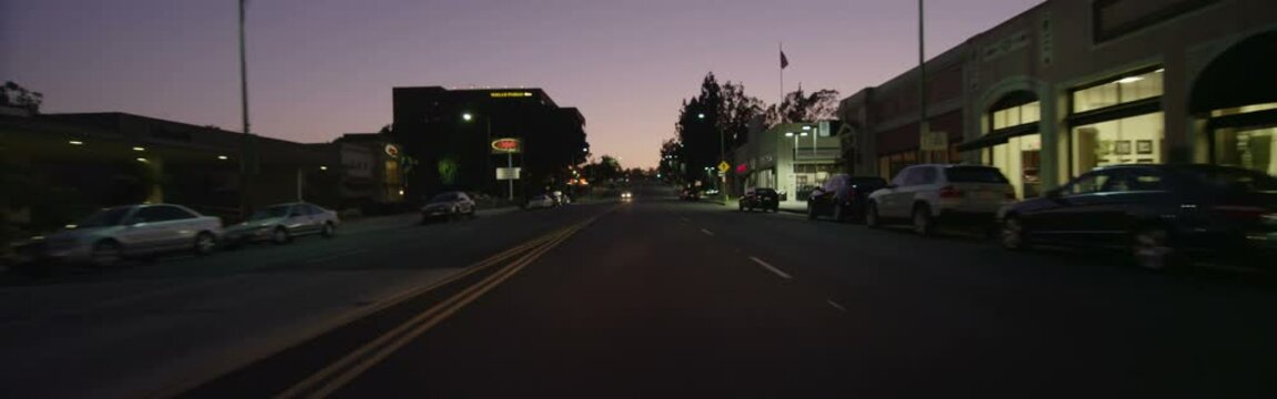 Front view of a Driving Plate: Car travels at dusk on West Colorado Boulevard in Pasadena, California from St John Avenue across Colorado Street Bridge to San Rafael Avenue.