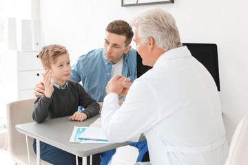 Fototapeta na wymiar Young man with his son having appointment at child psychologist office