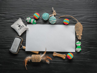 Flat lay composition with cat accessories on dark wooden background