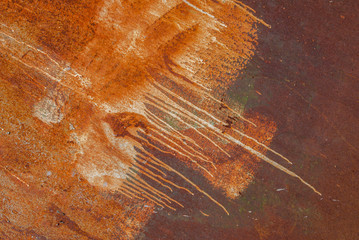 painted iron surface with a large rusty and metal corrosion, old background with peeling and cracking paint as background, orange texture