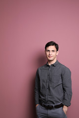 Obraz premium Portrait of confident young man on color background
