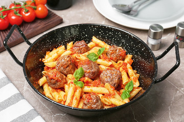 Pasta with meatballs and tomato sauce on grey background
