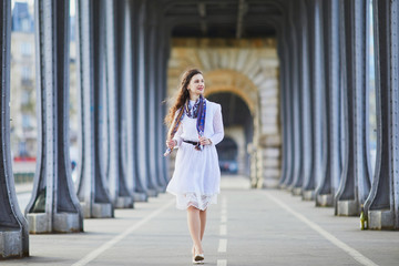 Woman in white dress on Bir-Hakeim bridge in Paris, France
