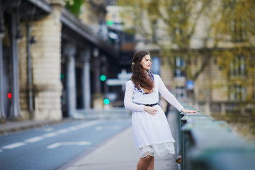 Woman in white dress on Bir-Hakeim bridge in Paris, France