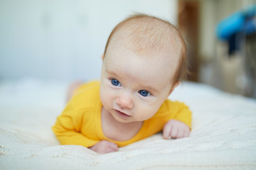 Baby girl relaxing in bedroom