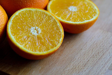 Oranges cut and set on wooden cutting board