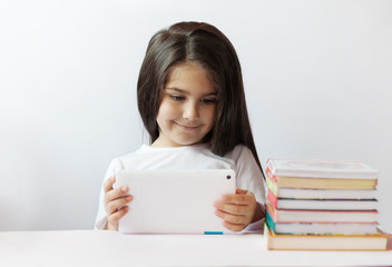 leisure, childhood, technology and people concept - cute little girl child with gadget. Toned image.