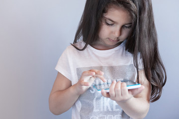 leisure, childhood, technology and people concept - child girl with tablet 