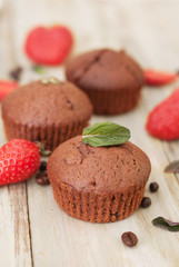 Chocolate Muffins with Strawberry Mint Leaves over rustic Gray Background Breakfast desert