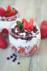 Strawberry Cake in Glass with White Crea mans Strawberry. Homemade summer dessert on white rustic table.