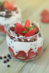 Strawberry Cake in Glass with White Crea mans Strawberry. Homemade summer dessert on white rustic table.