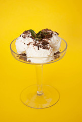 Vanilla Ice Cream with Chocoalte Topping Scoop in cup on Summer Yellow background