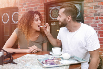 Couple on european vacation sitting in outdoors cafe