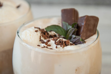 Iced Mocha Coffee with Whip Cream, Summer Drinking times. Coffee Beans. rustic textured Wooden Background. Mint Leaves