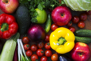 Assortment of different vegetables and fruits on wooden background. Top view. Closeup.