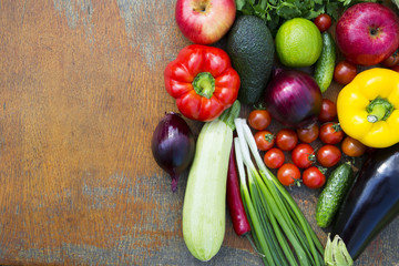 Set of different organic raw fruits and vegetables on wooden background. Copy space. Top view.