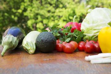 Composition of organic vegetables and fruits on rustic wooden table and blur background. Side view.