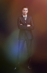 businessman standing on dark gradient background.