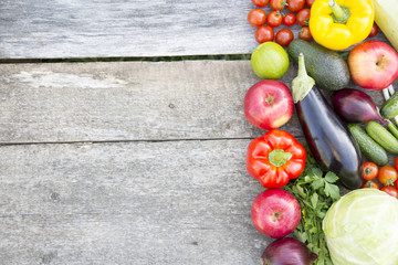 Set of various vegetables and fruits on rustic wooden background, top view. From above. Copy space.