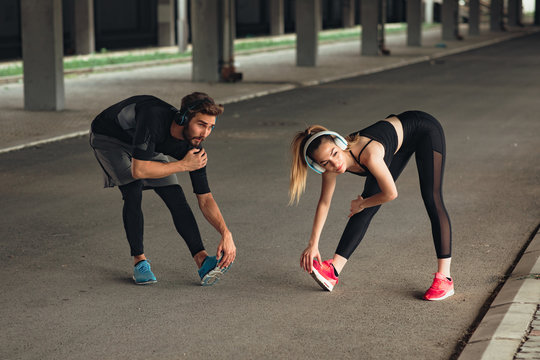 Young couple stretching before workout outdoor