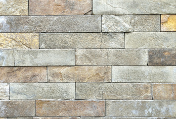 Brown stone wall, background, texture, rectangular natural stones of different shades