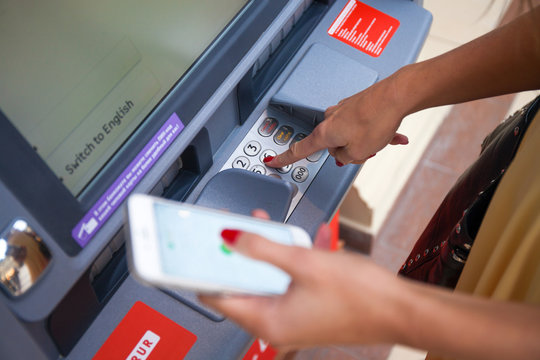 Close Up Of Hand Entering Pin At An ATM. Finger About To Press A Pin Code On A Pad