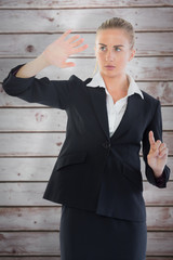 Businesswoman pointing somewhere against wooden planks