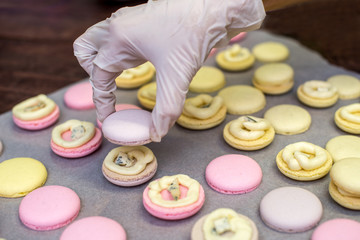 cooking, confectionery and baking concept - macarons on table