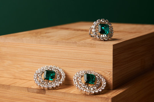 Emerald Ring And Pair Of Diamond Earrings In Gold, Wedding Jewelry With Luxury Gift Box , Close-up. Selective Focus