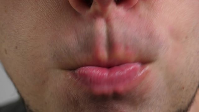 Man lick his lips. Closeup
