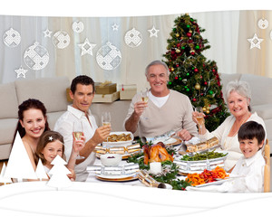 Family toasting with white wine in a Christmas dinner against christmas themed frame