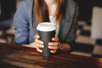 Cup of coffee in hand. 