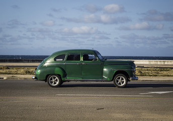 Fototapeta na wymiar old vintage American car walking through the streets of Havana, Cuba