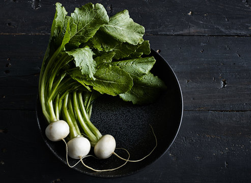 Overhead view of white radishes in pan on table