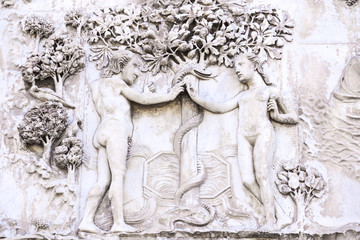 Detail of the facade of the Duomo of Orvieto, Italy. Marble bas-relief representing episodes of the bible. Adam and Eve
