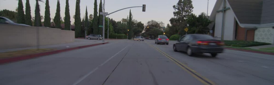 Rear view of a Driving Plate: Car travels on South Hill Avenue in Pasadena, California at dusk, crosses East Del Mar Boulevard, turns left on East Colorado Boulevard, and continues to Lake Avenue.