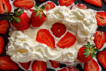 Lots of whipped cream, sliced and whole strawberries