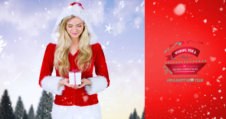 pretty girl in santa outfit holding gift against red vignette